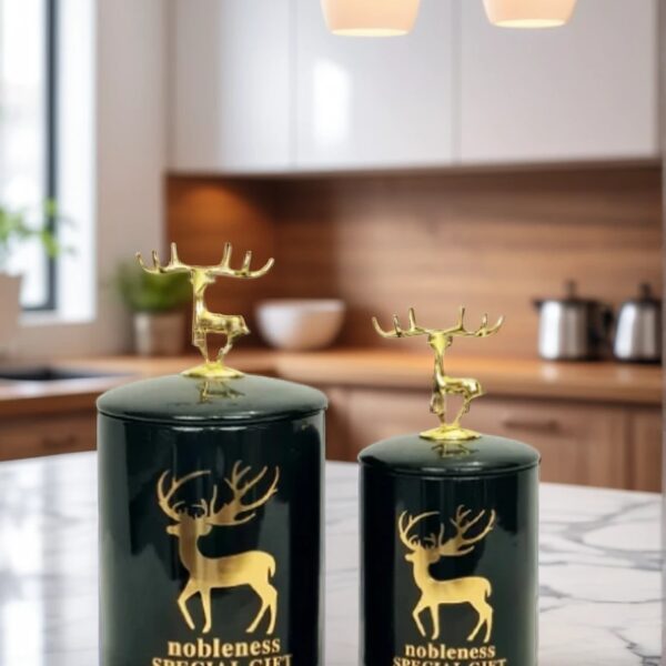 A pair of candy jars with antlers design on lid on a marble top