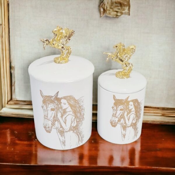 a candy jar set with golden horse lid on top of a wooden shelf